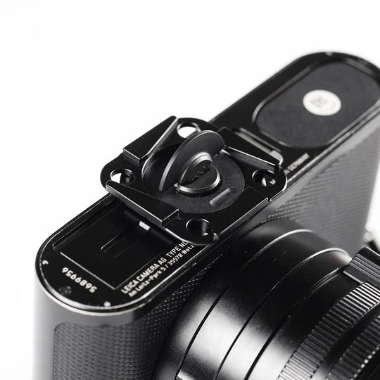 Close-up of a camera with a lens cap on a white background