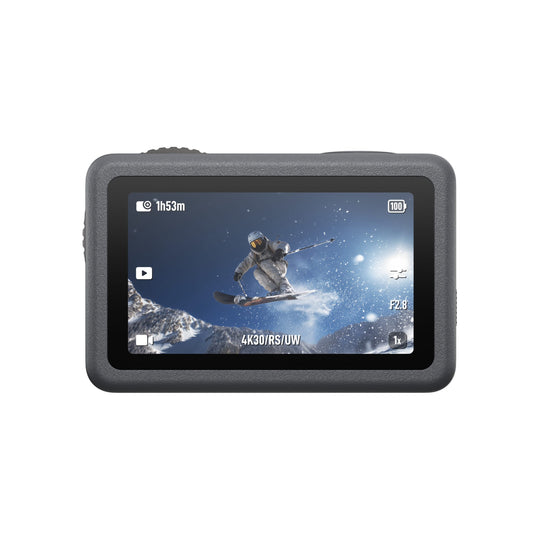 Action camera with screen displaying a skier in mid-air against a snowy background