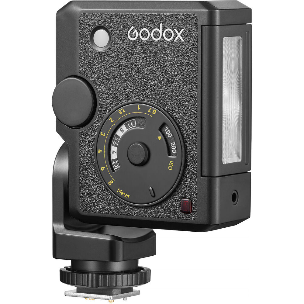 Front view of the Godox Lux Junior II Retro Camera Flash featuring a vintage leather-textured body, analog exposure calculator dial, optical sensor, vertically aligned flash tube, and single-pin hot shoe mount.