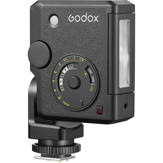 Front view of the Godox Lux Junior II Retro Camera Flash featuring a vintage leather-textured body, analog exposure calculator dial, optical sensor, vertically aligned flash tube, and single-pin hot shoe mount.