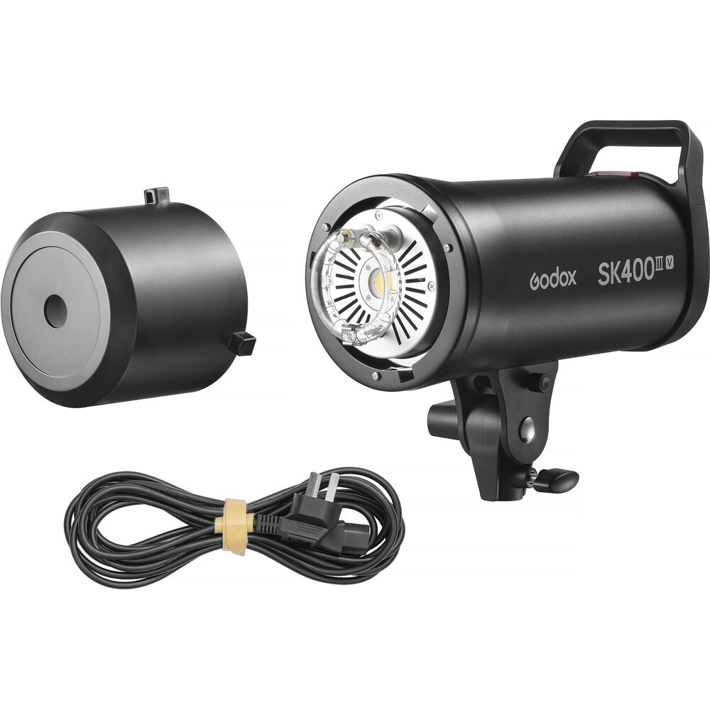 Godox SK400III-V studio flash strobe with included protective lamp cover and power cable.