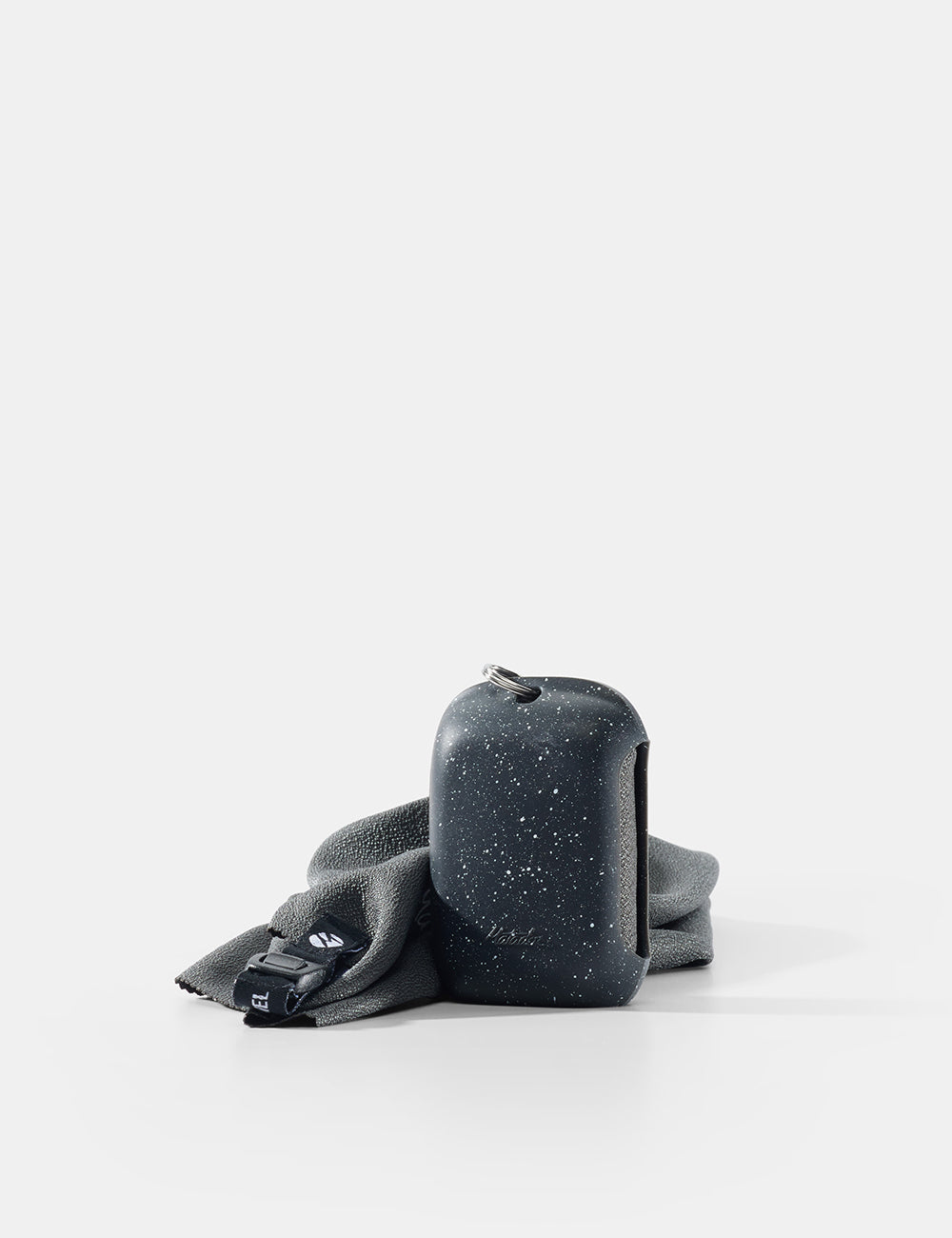 Black speckled container with gray cloth on a white background