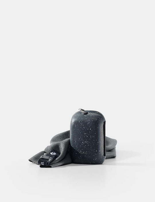 Black speckled container with gray cloth on a white background