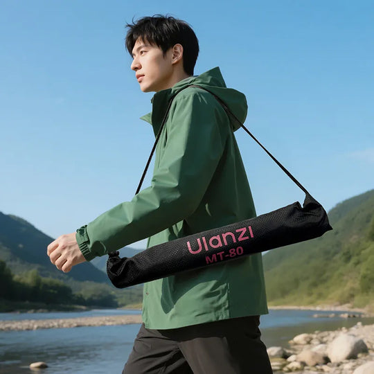 Person holding a Ulanzi MT-80 carrying case against a scenic background