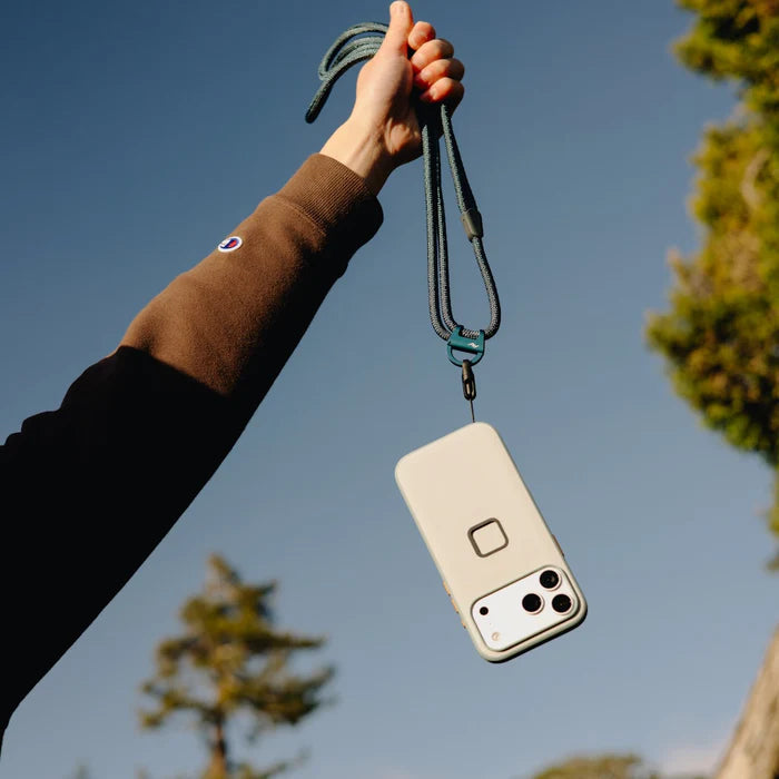 Phone case with a lanyard held up against a blue sky
