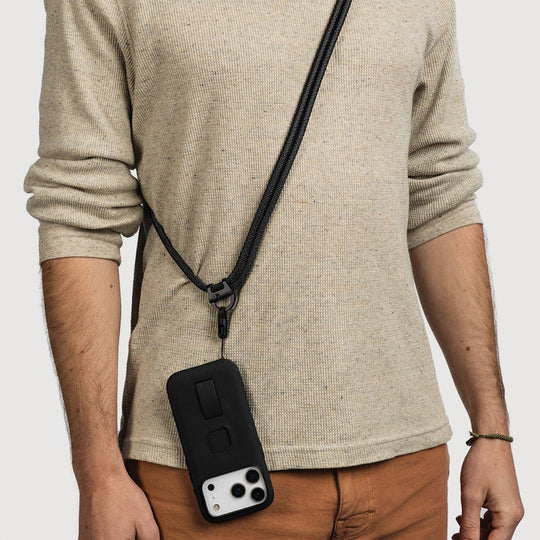 person with beige sweater weaing peak design mobile cross body multi strap