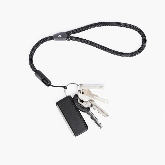 Black peak design mobile cuff with keys on a white background