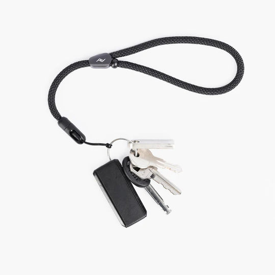 Black peak design mobile cuff with keys on a white background