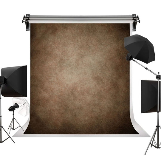 A photography backdrop set with a large brown textured backdrop roll suspended on a stand, surrounded by studio softbox lights on both sides against a white background.
