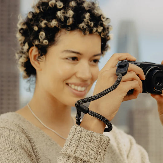 Person holding a camera with a blurred background