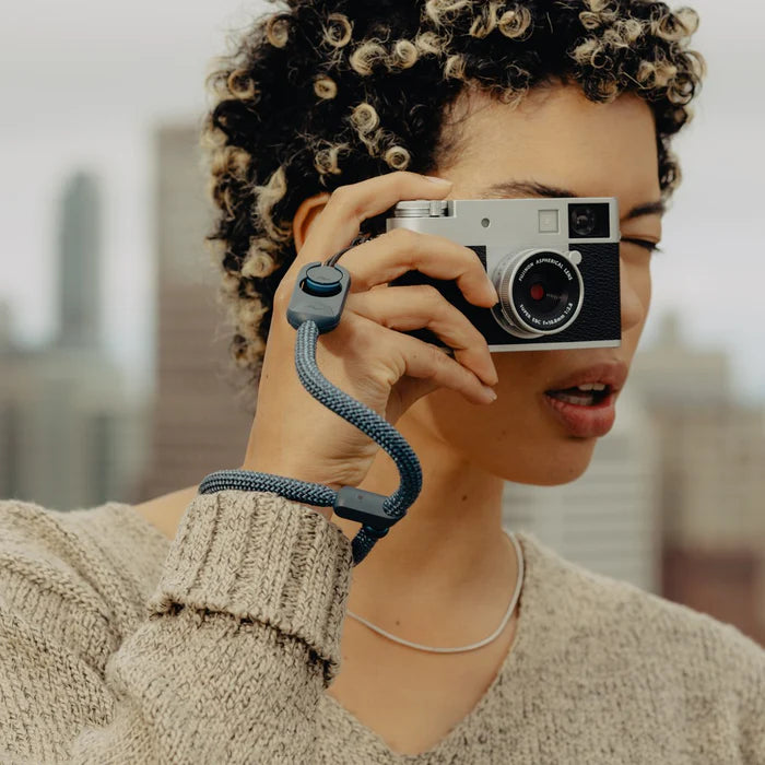 Person holding a vintage camera with a blurred background