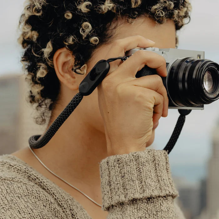 Person holding a camera with a blurred background