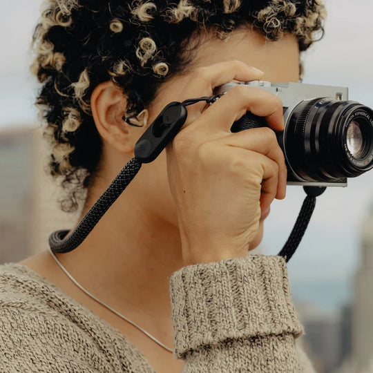 Person holding a camera with a blurred background