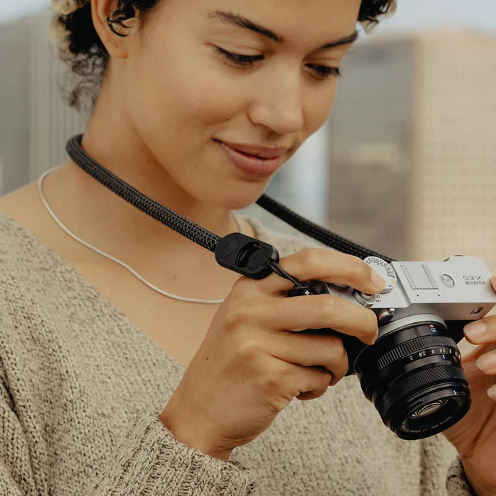 Person holding a camera with a blurred background