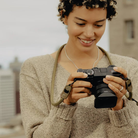 Woman holding a camera with a blurred background