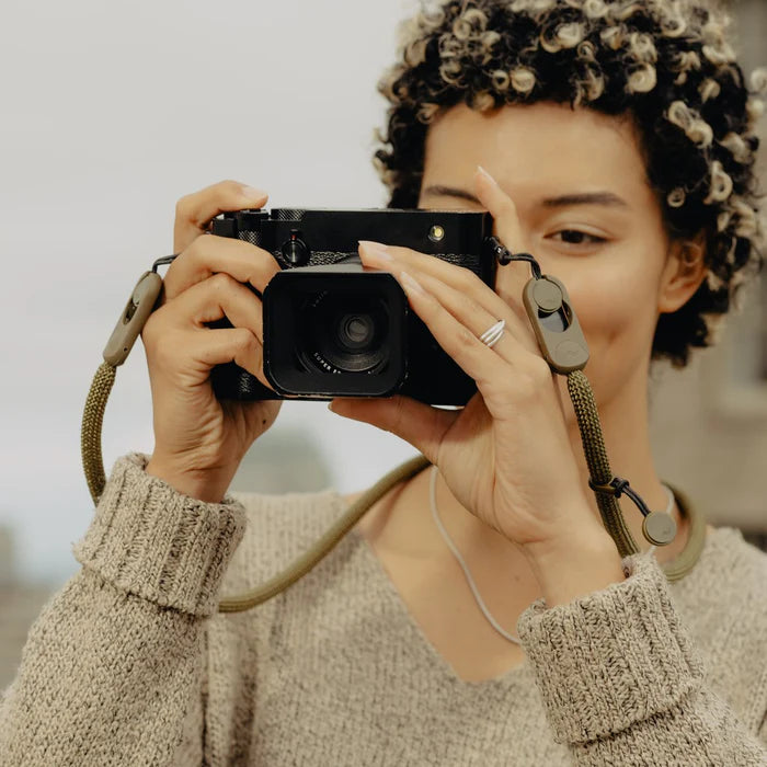 Person holding a camera with a blurred background