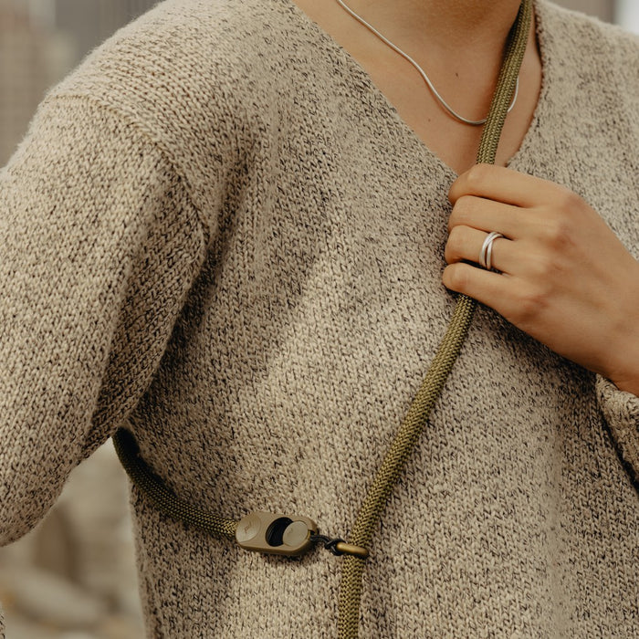 Close-up of a person wearing a Peak Design Form Rope Camera Strap.