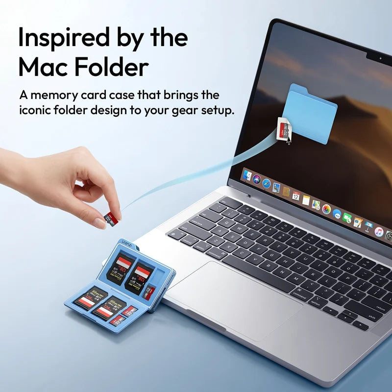 Ulanzi DC01 blue memory card reader case opened next to a laptop, storing SD and TF cards with a design inspired by the macOS folder icon.