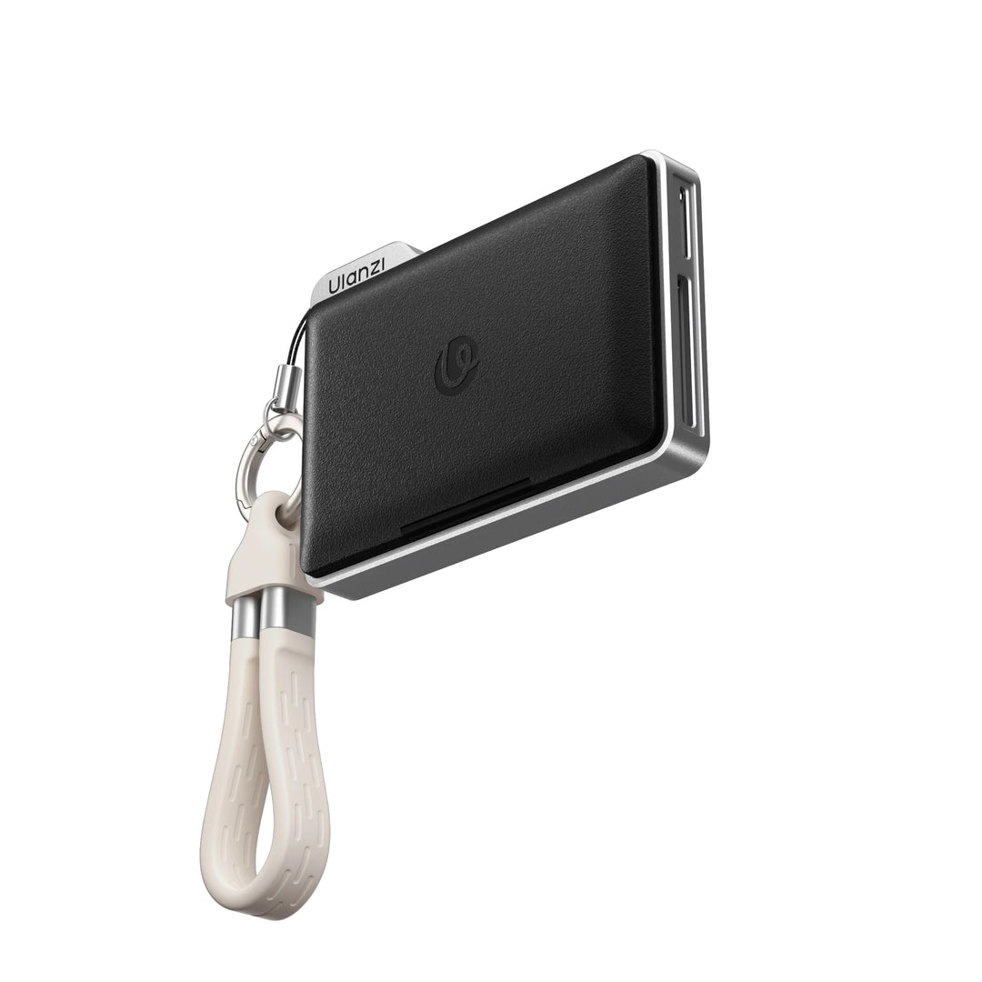 Black leatherette Ulanzi DC01 2-in-1 memory card reader with a lanyard strap floating against a white background.