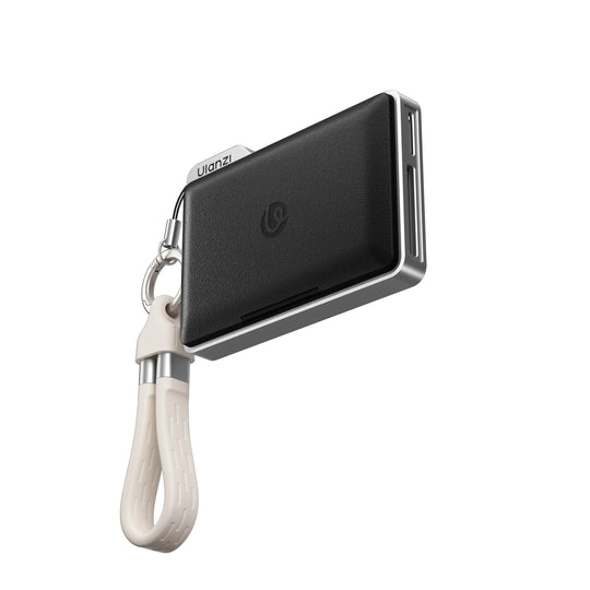 Black leatherette Ulanzi DC01 2-in-1 memory card reader with a lanyard strap floating against a white background.