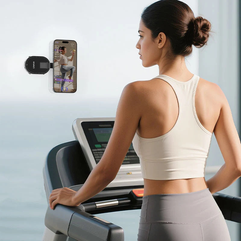 Ulanzi MA39 MagLock suction mount attached to a treadmill console holding an iPhone during a gym workout session.