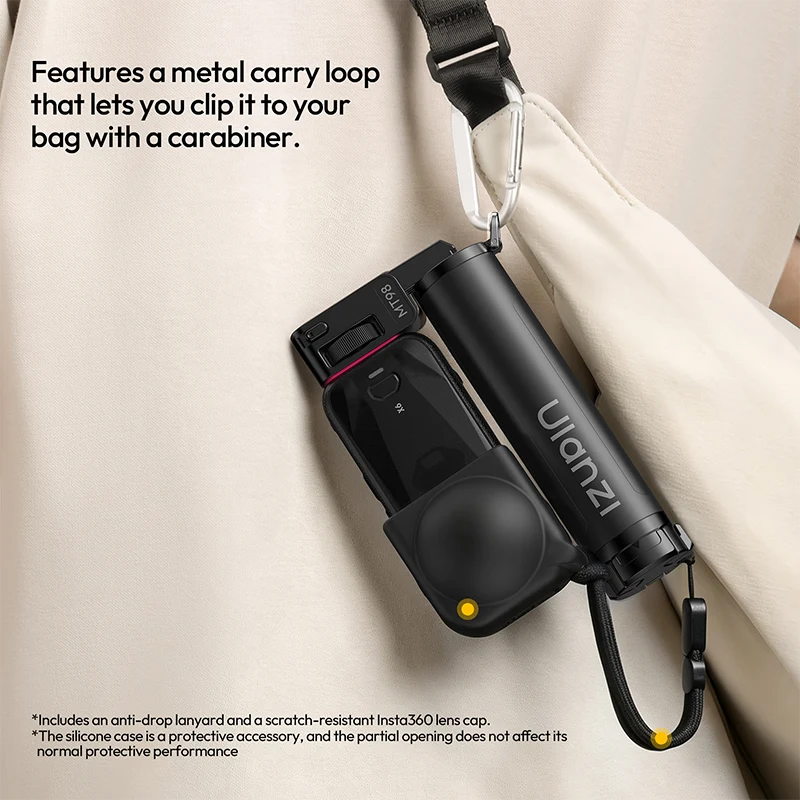 Ulanzi MT98 selfie stick attached to a shoulder bag strap via its integrated metal carry loop and carabiner clip.